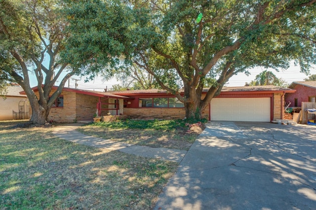 ranch-style home with a garage and a front yard