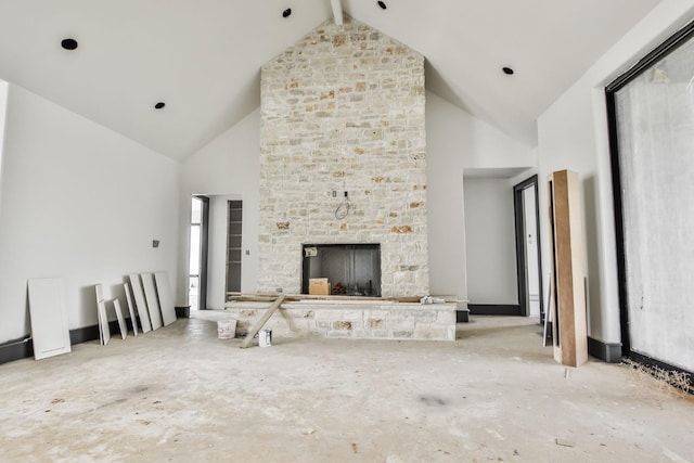 unfurnished living room with a fireplace, high vaulted ceiling, and beam ceiling