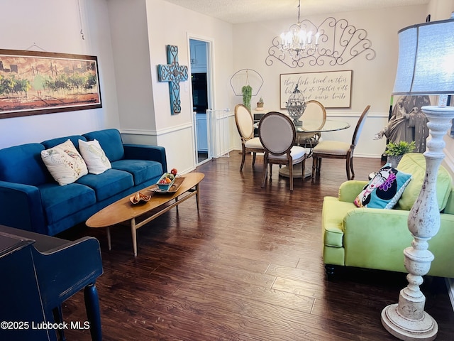living area with a notable chandelier and wood finished floors