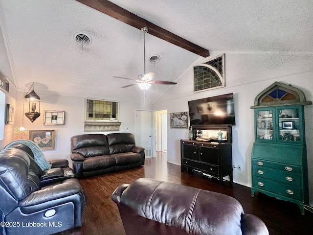 living area with wood finished floors, a ceiling fan, lofted ceiling with beams, a textured ceiling, and visible vents