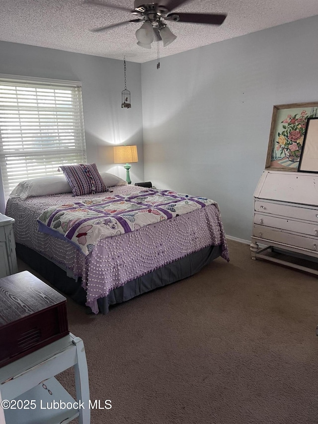 carpeted bedroom with a ceiling fan and a textured ceiling