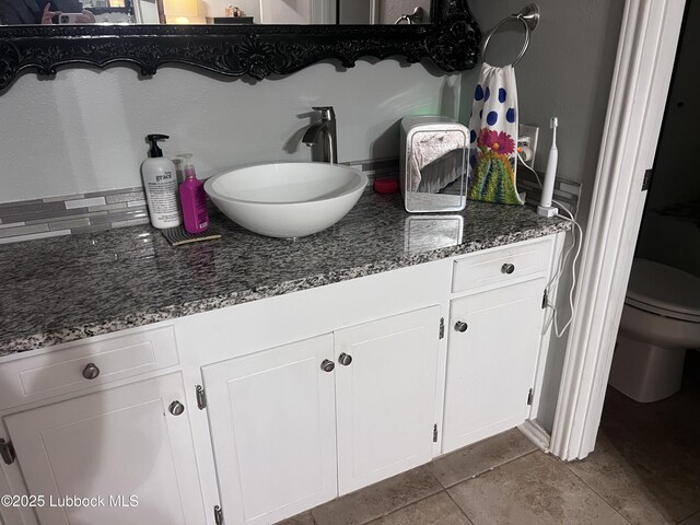bathroom featuring toilet and vanity