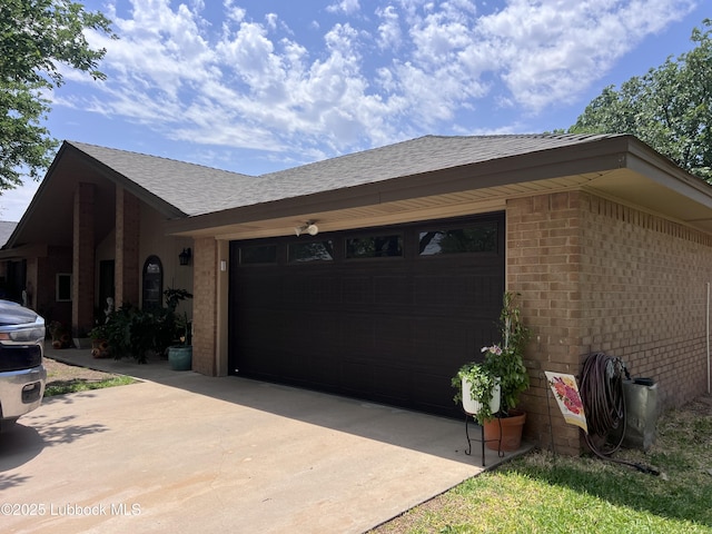 view of home's exterior featuring driveway, brick siding, a shingled roof, and an attached garage