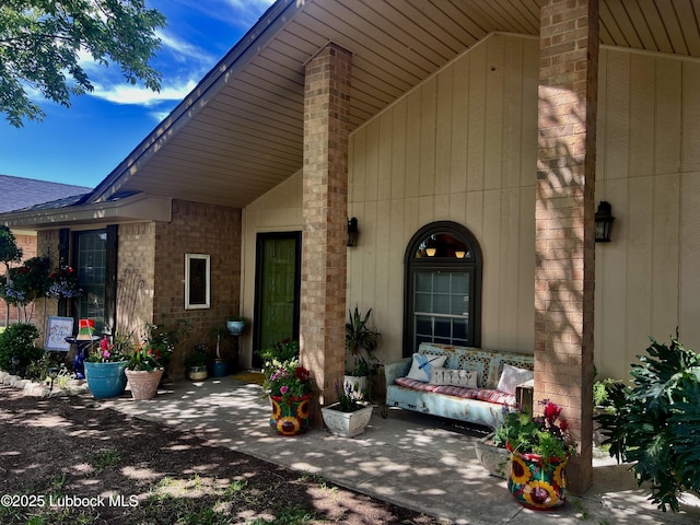 view of exterior entry with a patio