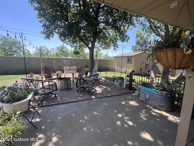 view of patio / terrace with a fenced backyard and an outbuilding
