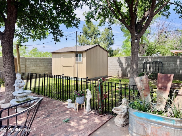 view of patio / terrace with a fenced backyard, a storage shed, a wooden deck, and an outbuilding