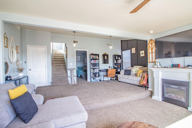 living room featuring carpet floors and ceiling fan