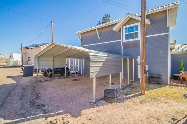 rear view of property with a carport