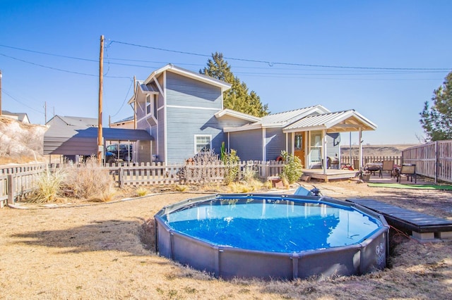 back of house with a swimming pool side deck