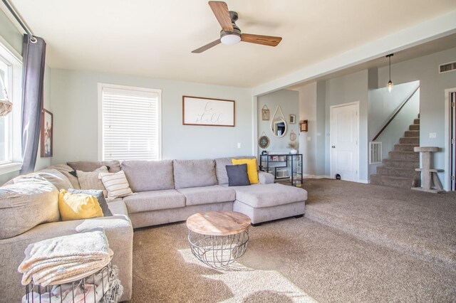 living room featuring carpet and ceiling fan