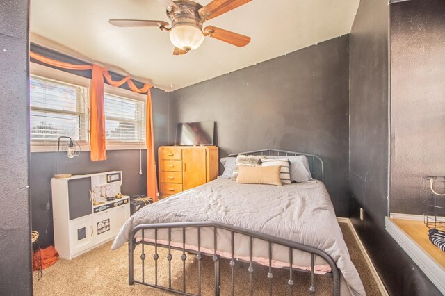 bedroom featuring ceiling fan and light colored carpet