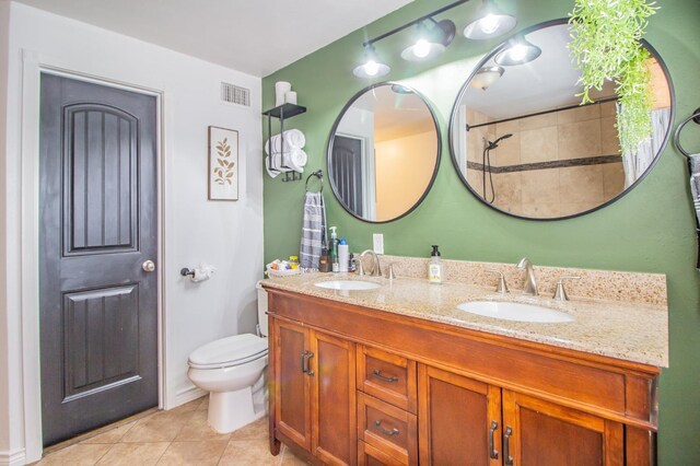 bathroom with vanity, toilet, and tile patterned flooring