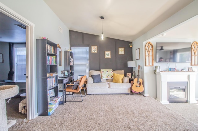 carpeted living room featuring lofted ceiling