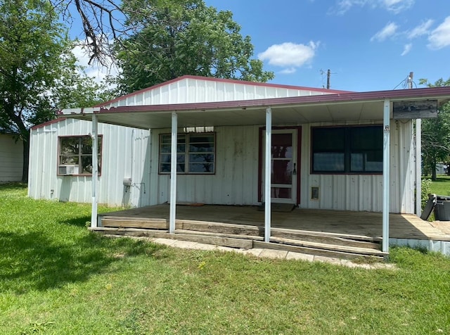 rear view of property with a lawn