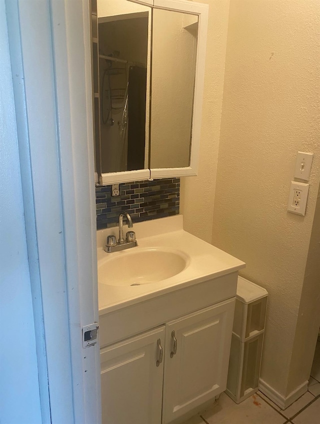 bathroom with tile patterned floors, vanity, and decorative backsplash