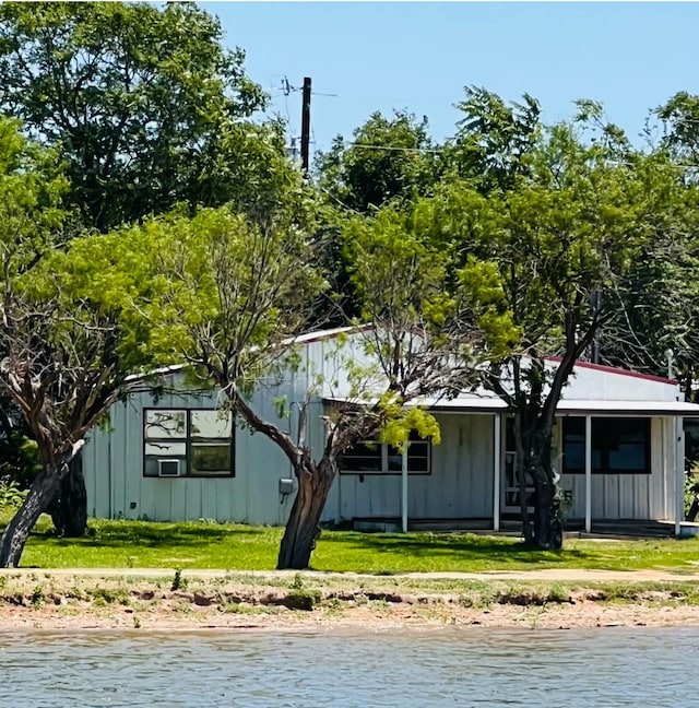 exterior space with a water view and a front yard