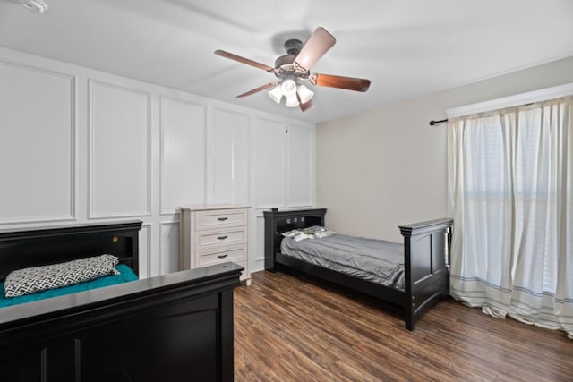 bedroom with dark hardwood / wood-style flooring and ceiling fan