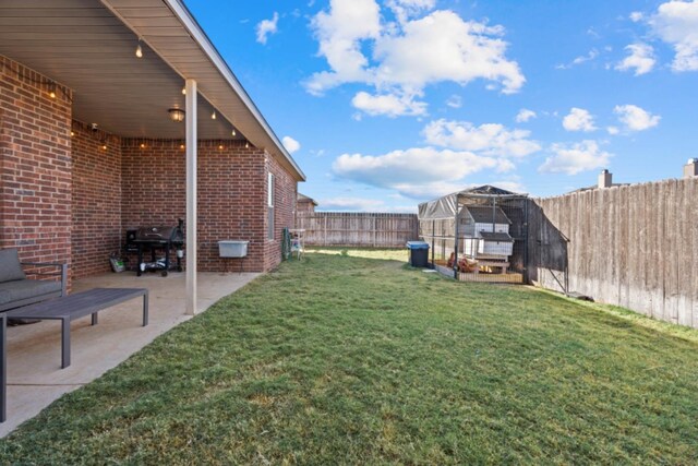 view of yard with an outdoor structure and a patio