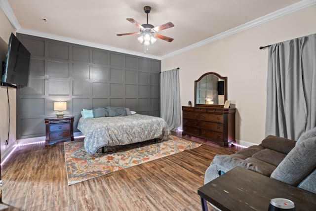 bedroom featuring ceiling fan, ornamental molding, and dark hardwood / wood-style flooring