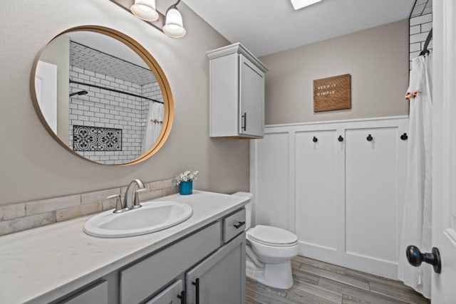 bathroom featuring vanity, hardwood / wood-style flooring, toilet, and a shower with shower curtain