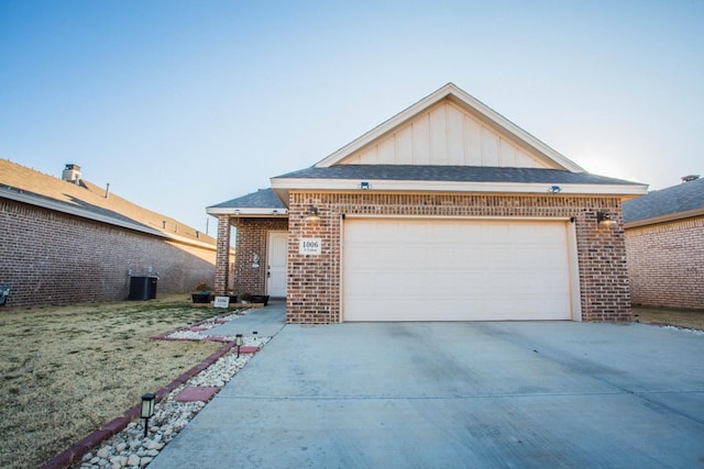 view of front of property with a garage, central AC, and a front yard