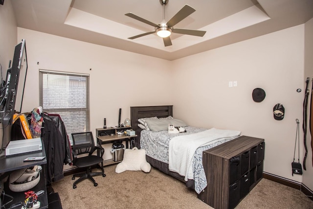 bedroom featuring carpet floors, a raised ceiling, and ceiling fan