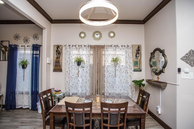 dining space featuring crown molding and dark wood-type flooring