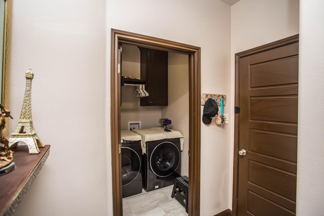 laundry room with cabinets and washing machine and clothes dryer