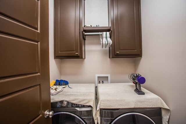 laundry room with cabinets and separate washer and dryer