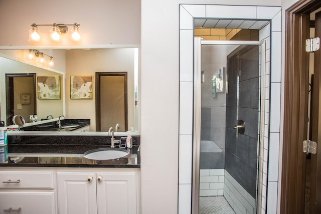 bathroom featuring walk in shower and vanity