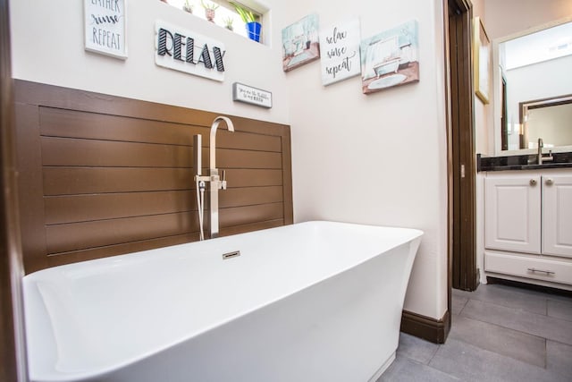 bathroom featuring vanity and a tub to relax in