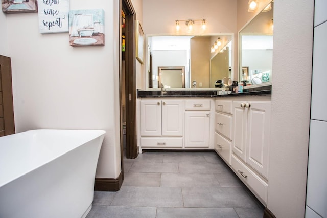 bathroom with vanity, tile patterned flooring, and a bathing tub