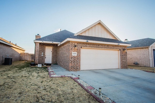 view of front facade with a garage, central AC, and a front yard