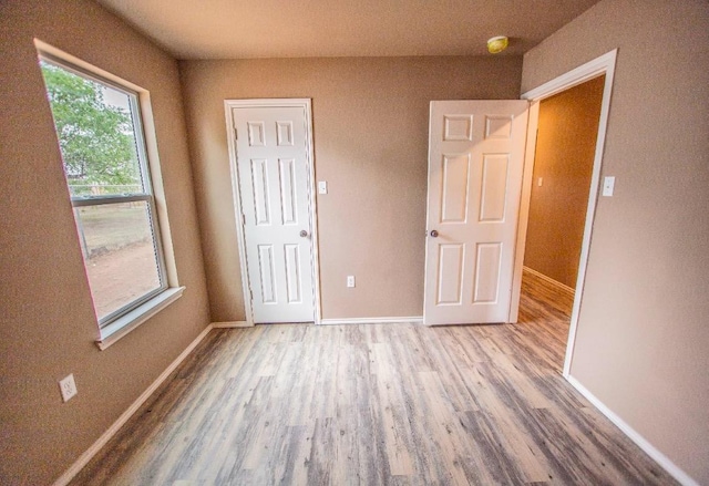 unfurnished bedroom with hardwood / wood-style flooring