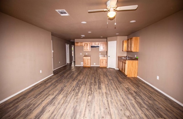 kitchen featuring dark hardwood / wood-style flooring, light brown cabinetry, sink, and ceiling fan