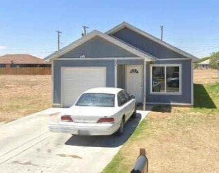 view of front facade with a garage and a front lawn