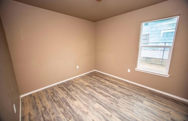 unfurnished room with hardwood / wood-style flooring