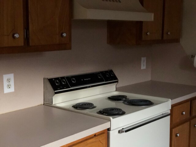 kitchen with electric stove and extractor fan