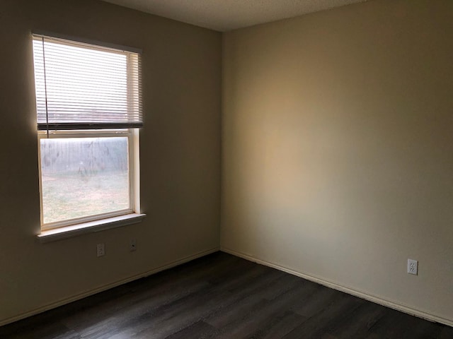 unfurnished room featuring dark hardwood / wood-style flooring