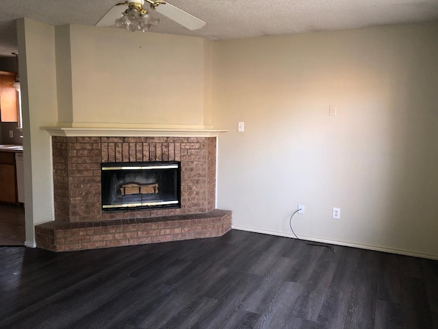 unfurnished living room featuring ceiling fan, hardwood / wood-style flooring, a fireplace, and a textured ceiling