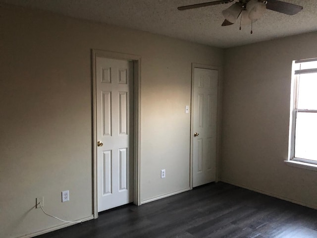 unfurnished bedroom with dark hardwood / wood-style floors and a textured ceiling