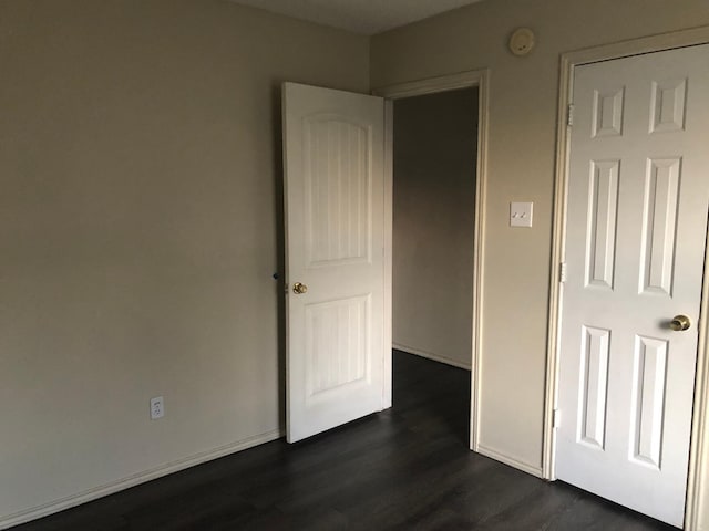 unfurnished bedroom featuring dark hardwood / wood-style floors