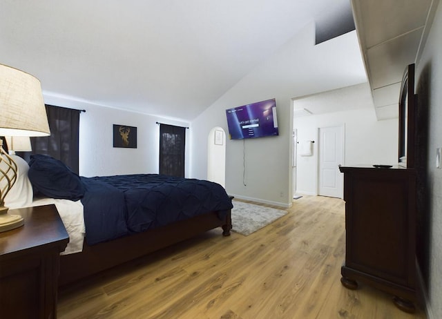 bedroom featuring lofted ceiling and hardwood / wood-style flooring