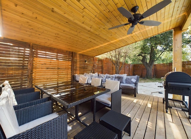 deck with ceiling fan, an outdoor living space, and a grill