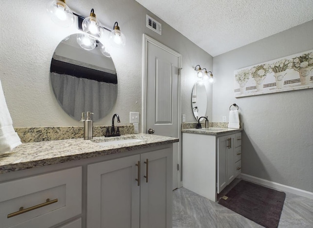 bathroom featuring vanity and a textured ceiling