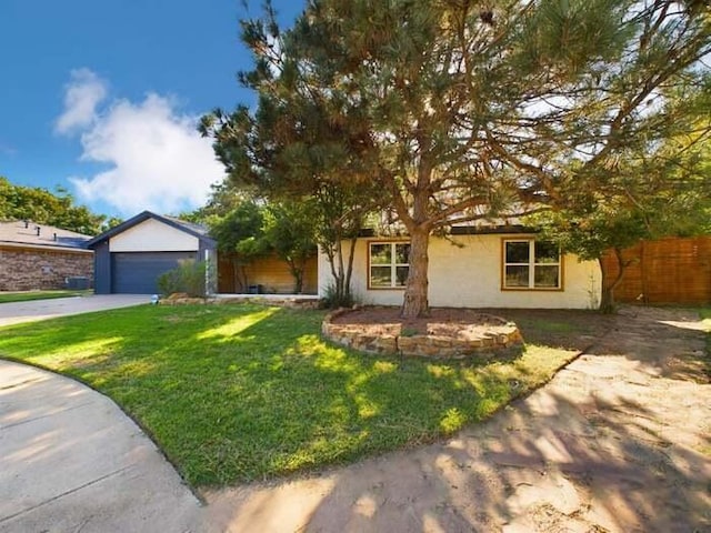 view of front facade with a garage and a front lawn