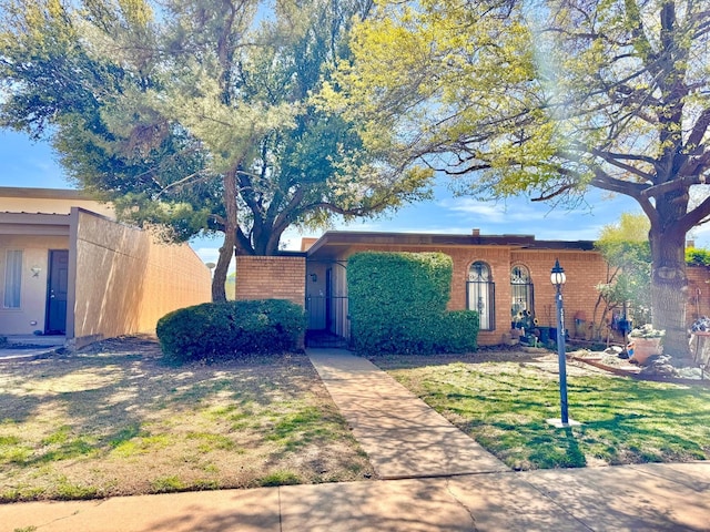 ranch-style house with a front lawn