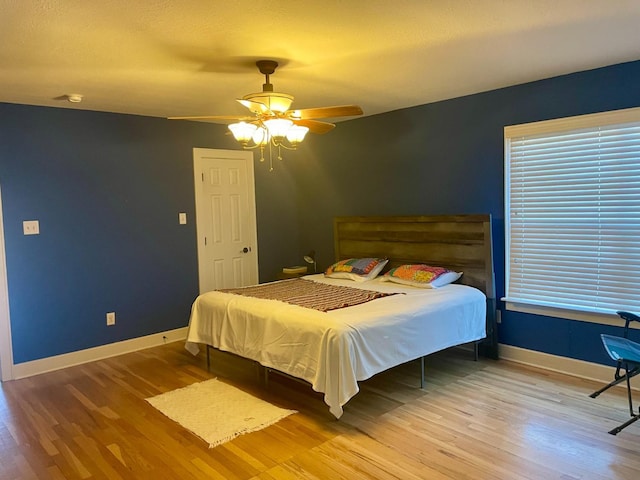 bedroom featuring hardwood / wood-style flooring and ceiling fan