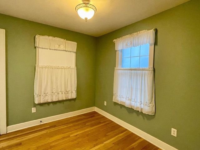 empty room with hardwood / wood-style flooring