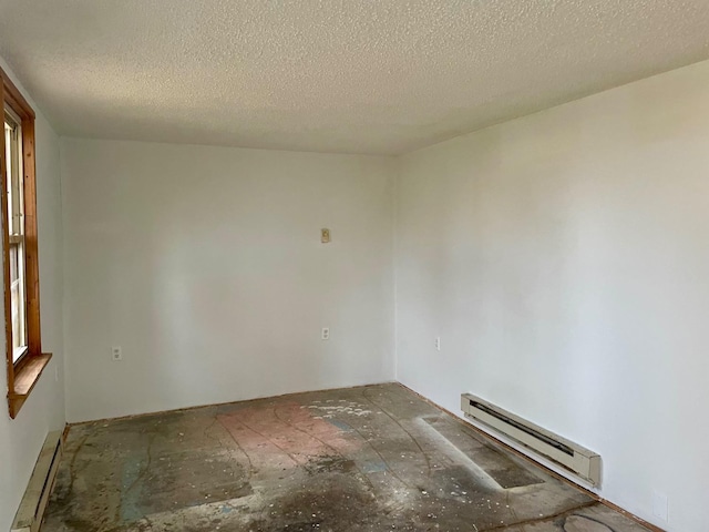 spare room with a textured ceiling and baseboard heating